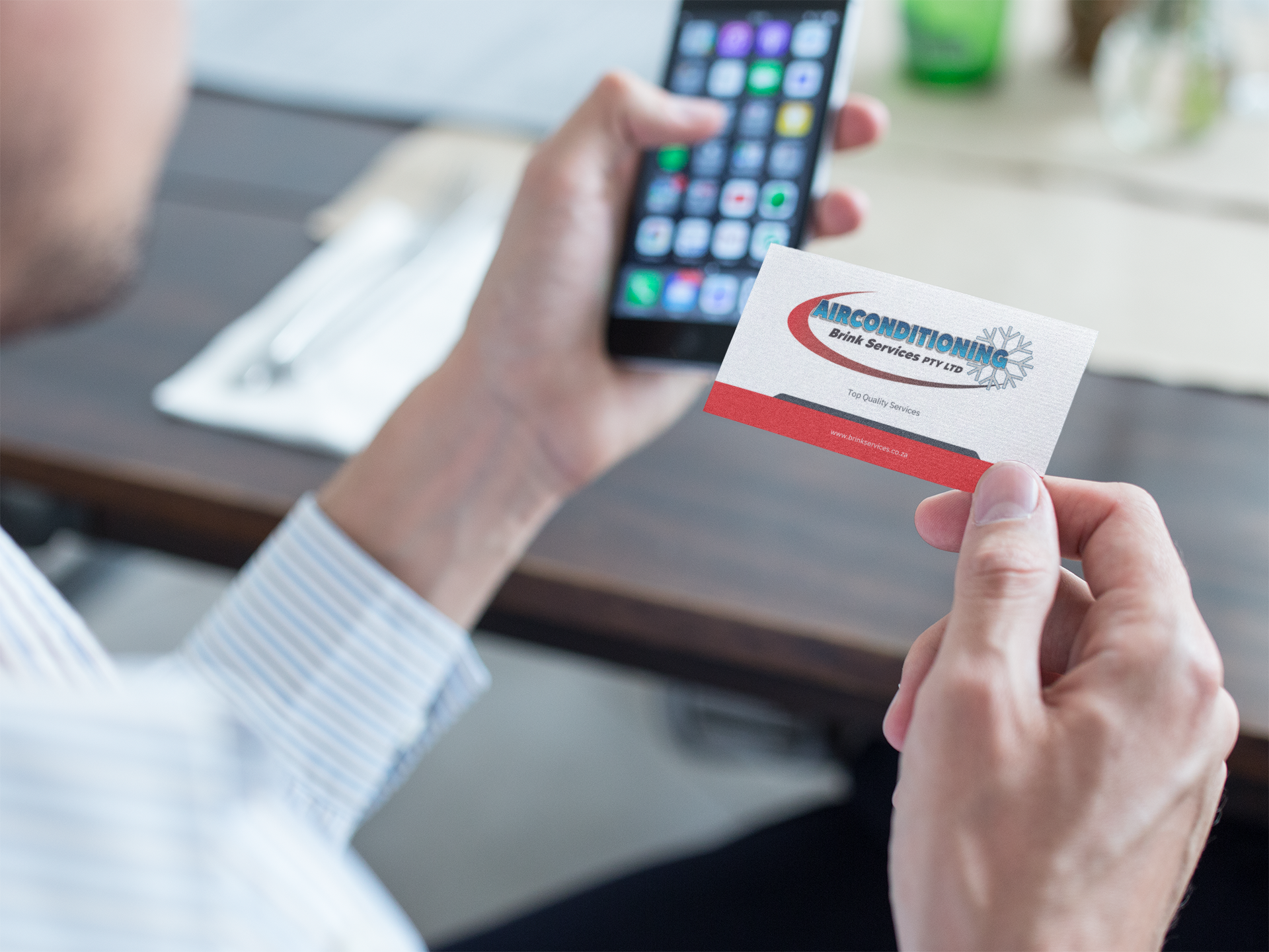 mockup-of-a-business-man-using-a-business-card-to-contact-a-person-with-his-phone-a15032